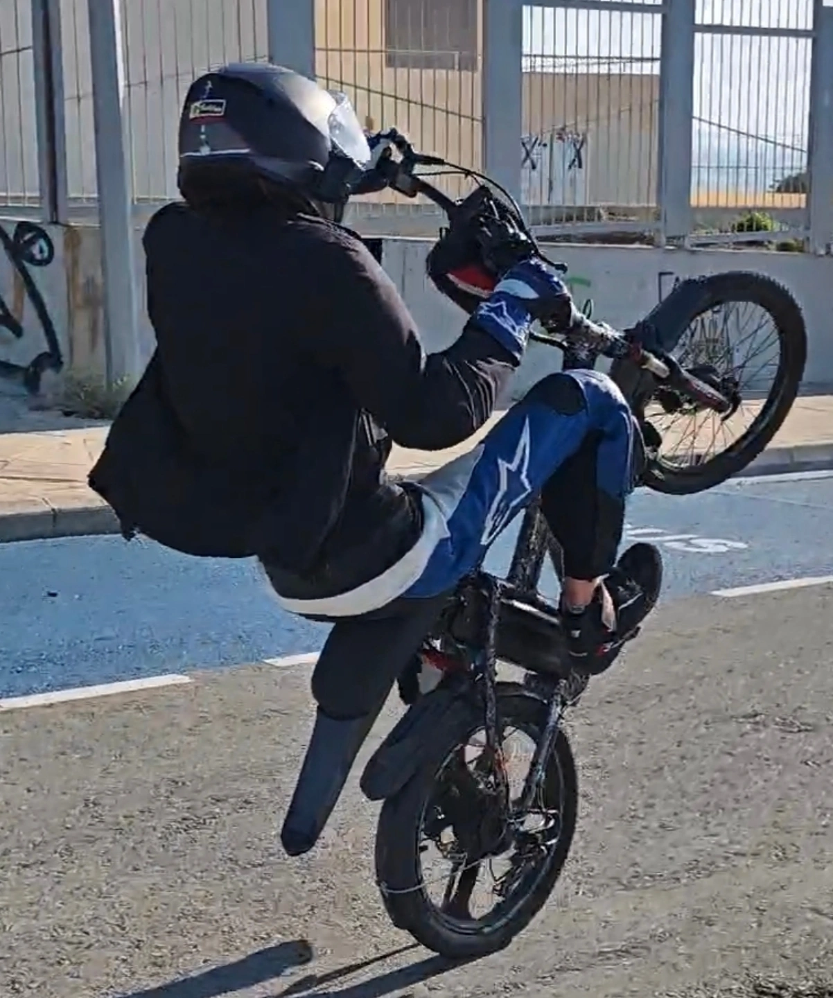 EbikeStr performing a wheelie on the stunt bike